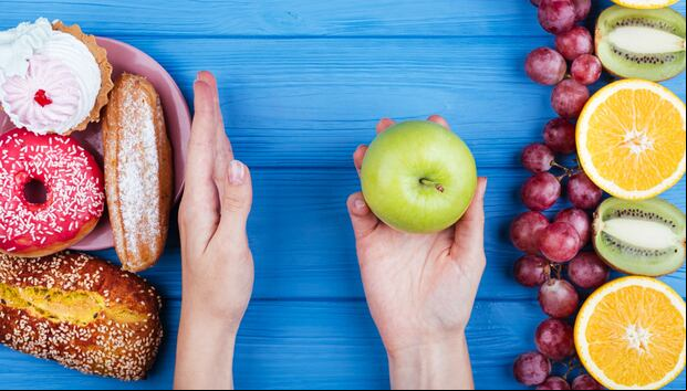 En esta imagen se aprecia cómo una persona prefiere los alimentos saludables en vez de los dulces. (Foto: freepik)